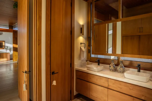 a bathroom with a double vanity sink and a mirror