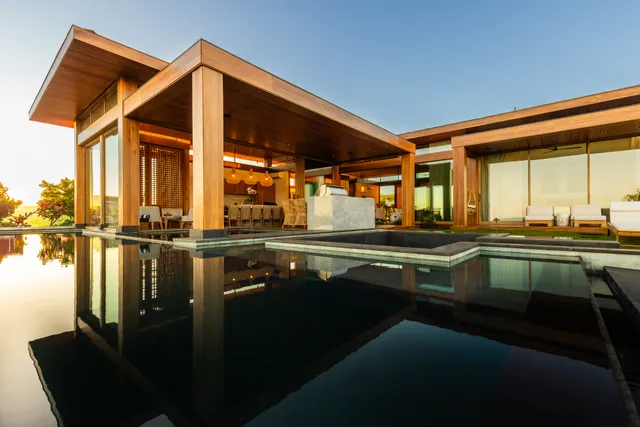 a backyard of a house with a table and chairs
