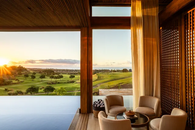 a balcony with furniture and a floor to ceiling window