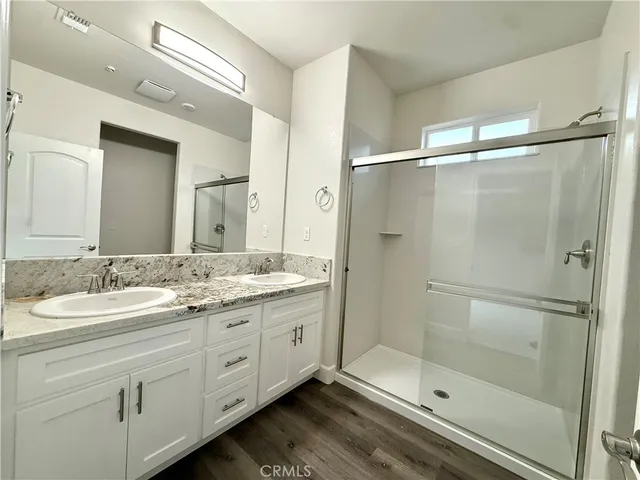 a bathroom with a granite countertop sink mirror and shower