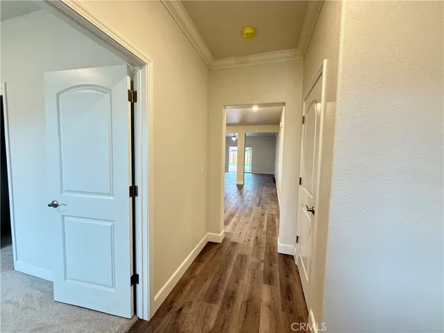 a view of a room with wooden floor