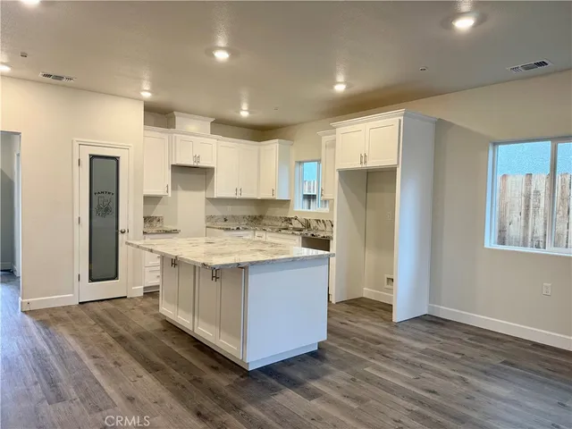 a kitchen with stainless steel appliances granite countertop a stove and a refrigerator