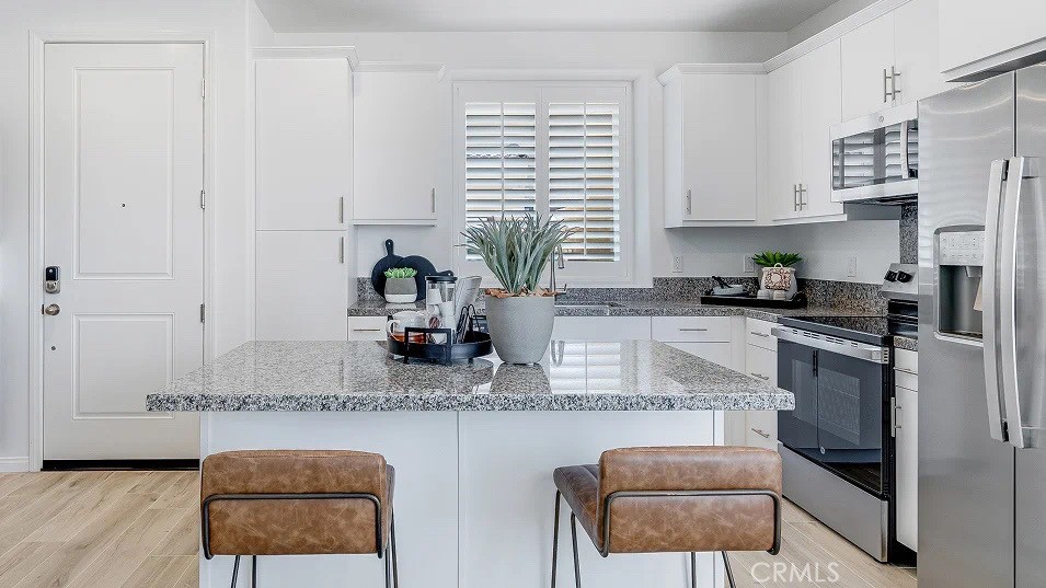 1209 Yeager Avenue Rialto, CA 92376 - Photo 2 of 20 a kitchen with stainless steel appliances granite countertop a sink and a refrigerator