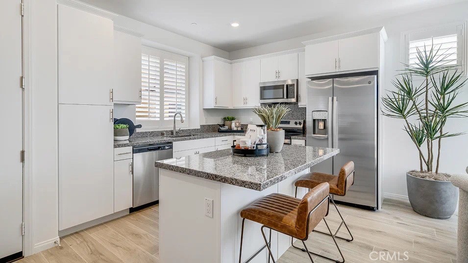 1209 Yeager Avenue Rialto, CA 92376 - Photo 4 of 20 a kitchen with stainless steel appliances granite countertop a stove a sink a refrigerator and a granite counter tops
