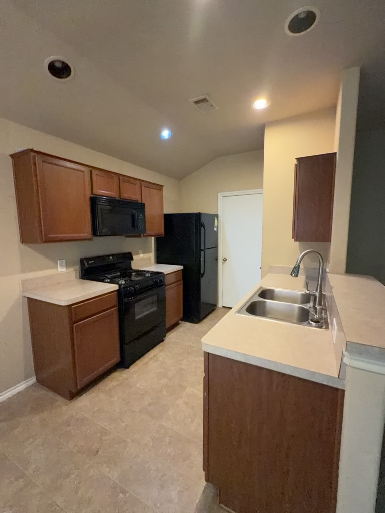 811 Lovebug Lane Conroe, TX 77301 - Photo 4 of 9 a kitchen with a sink appliances and cabinets