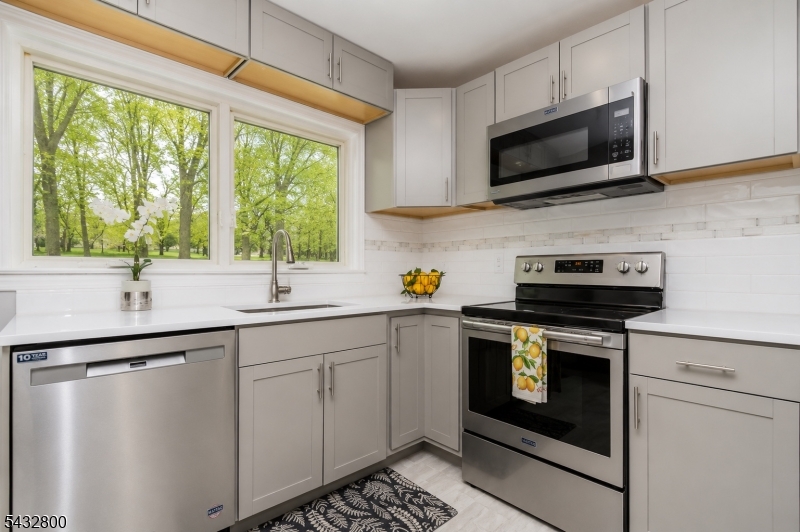 3 Castle Rock Road Lake Hopatcong, NJ 07849 - Photo 4 of 14 a kitchen with a sink stove and microwave