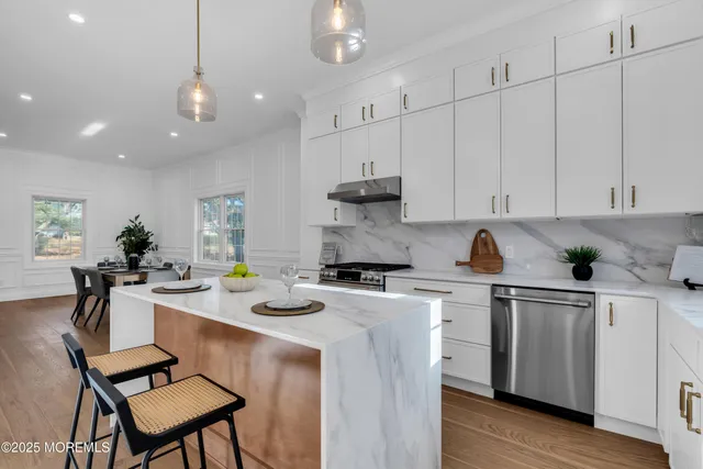 a kitchen with appliances a sink and cabinets