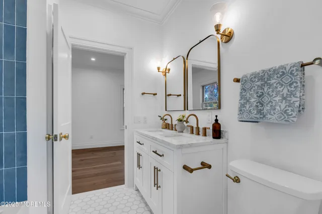 a bathroom with a toilet sink and mirror