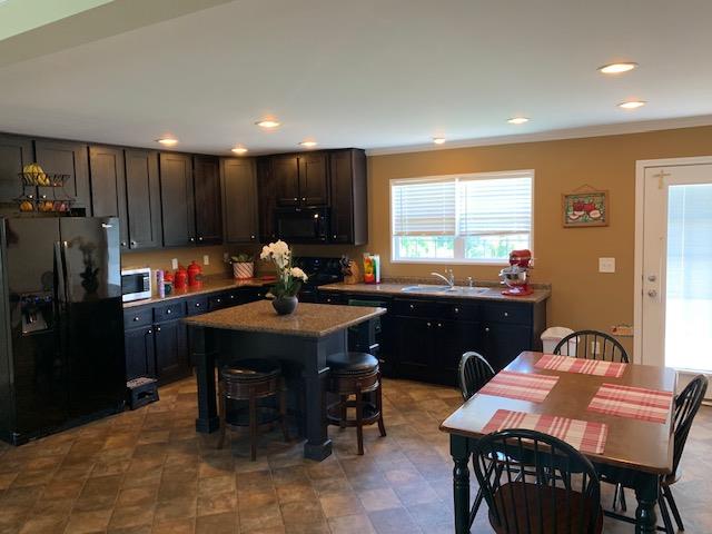 1136 Wrights Mill Road Spring Hill, TN 37174 - Photo 4 of 19 a living room with dining table and a refrigerator