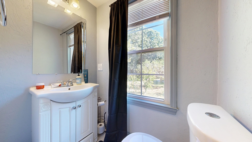 970 North Main Street Raynham, MA 02767 - Photo 16 of 42 a bathroom with a sink a toilet and a mirror
