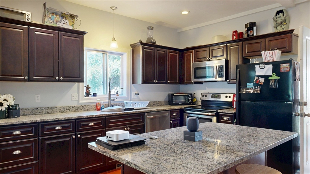 970 North Main Street Raynham, MA 02767 - Photo 3 of 42 a kitchen with a sink a stove and cabinets