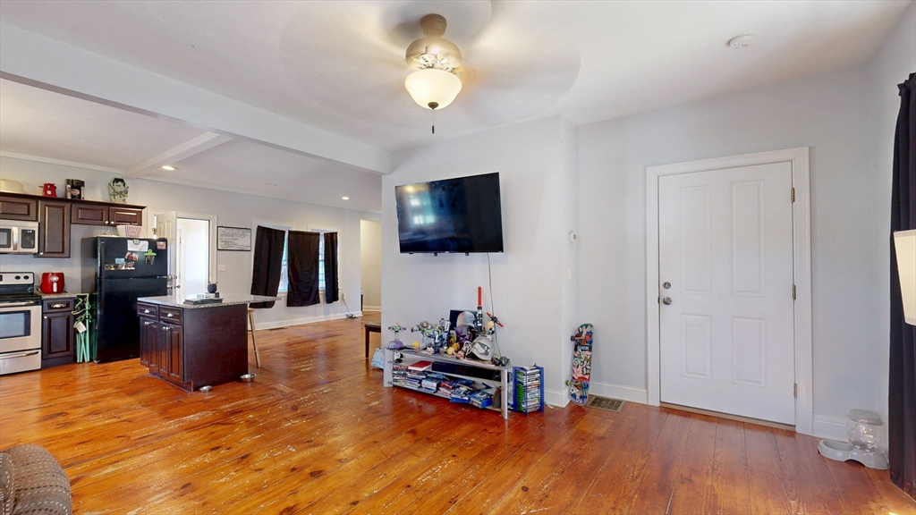970 North Main Street Raynham, MA 02767 - Photo 4 of 42 a living room with furniture and a flat screen tv