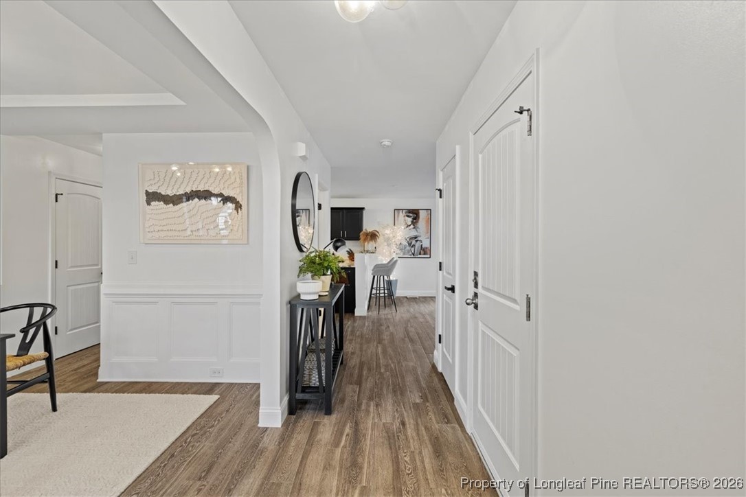 681 New Castle Lane Spring Lake, NC 28390 - Photo 11 of 50 a view of a hallway with wooden floor and a living room