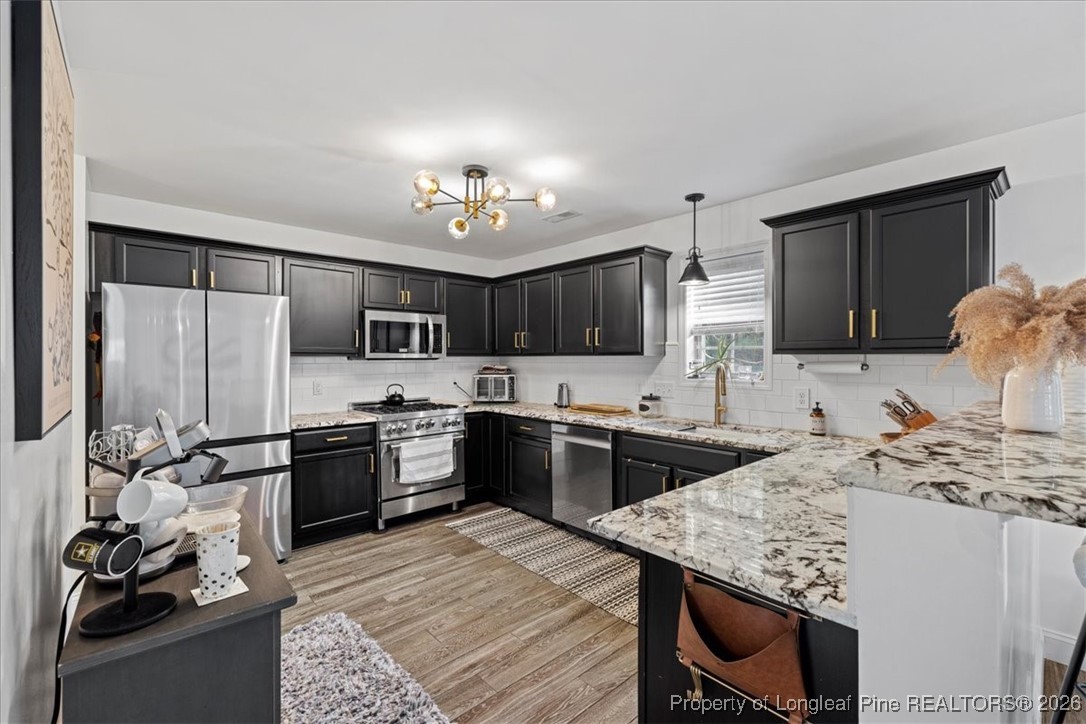 681 New Castle Lane Spring Lake, NC 28390 - Photo 13 of 50 a kitchen with a stove sink and microwave