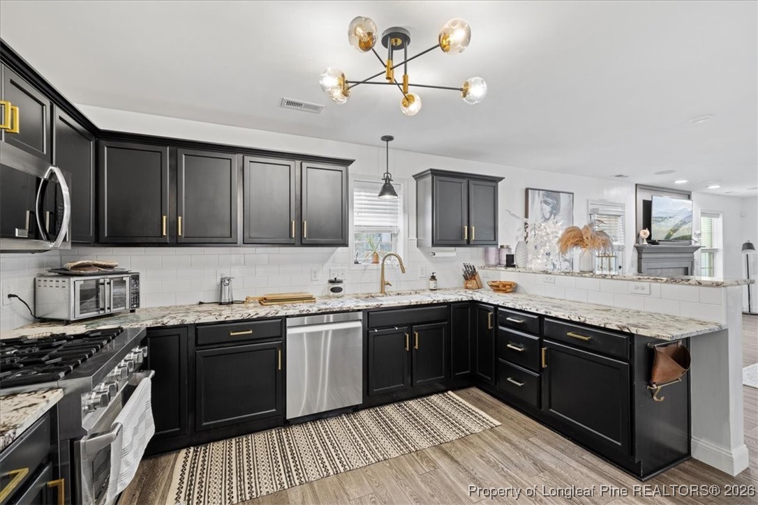 681 New Castle Lane Spring Lake, NC 28390 - Photo 15 of 50 a kitchen with a sink stainless steel appliances and cabinets