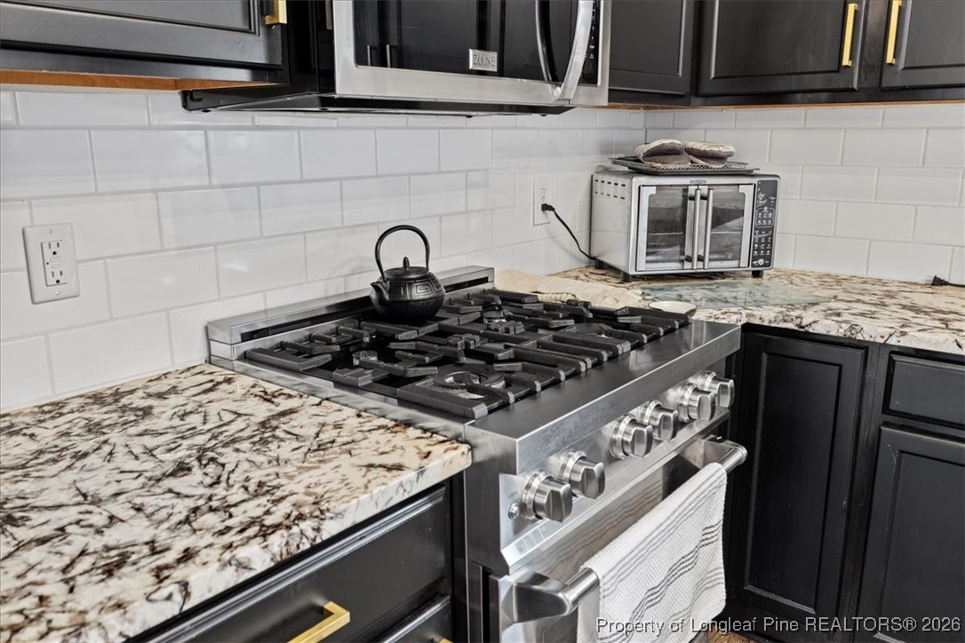 681 New Castle Lane Spring Lake, NC 28390 - Photo 16 of 50 a stove top oven sitting inside of a kitchen