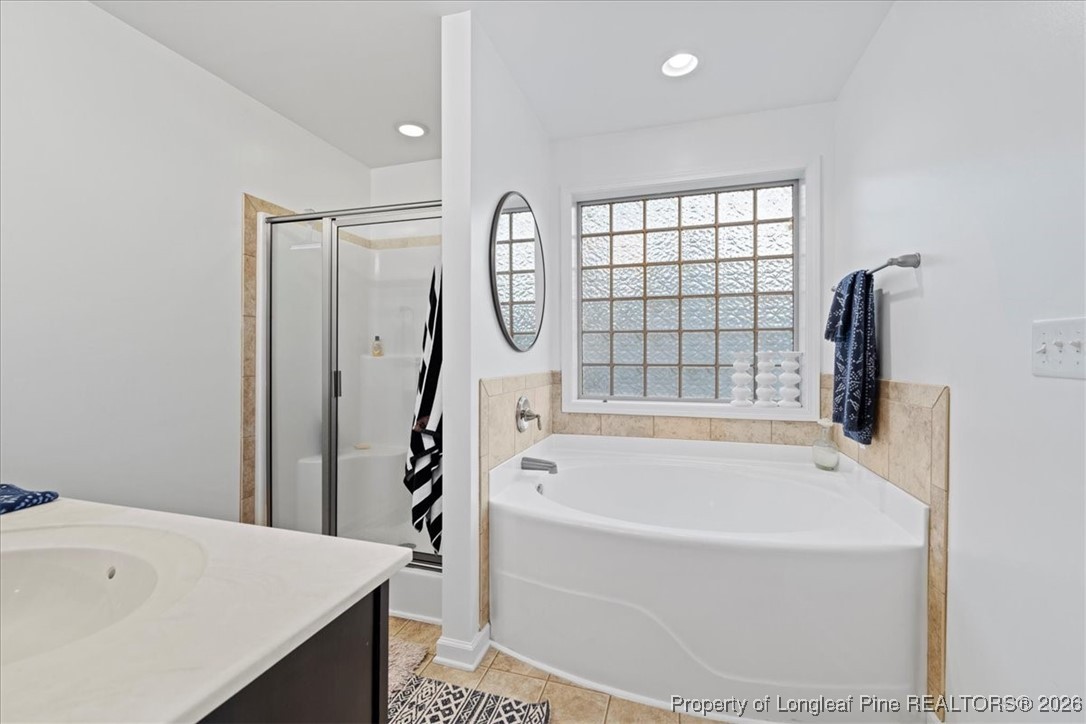 681 New Castle Lane Spring Lake, NC 28390 - Photo 31 of 50 a bathroom with a bathtub and a shower