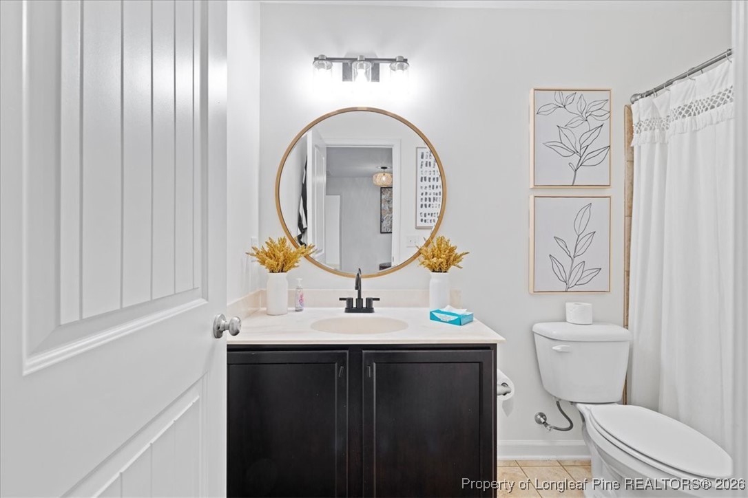 681 New Castle Lane Spring Lake, NC 28390 - Photo 36 of 50 a bathroom with a toilet a sink and a mirror