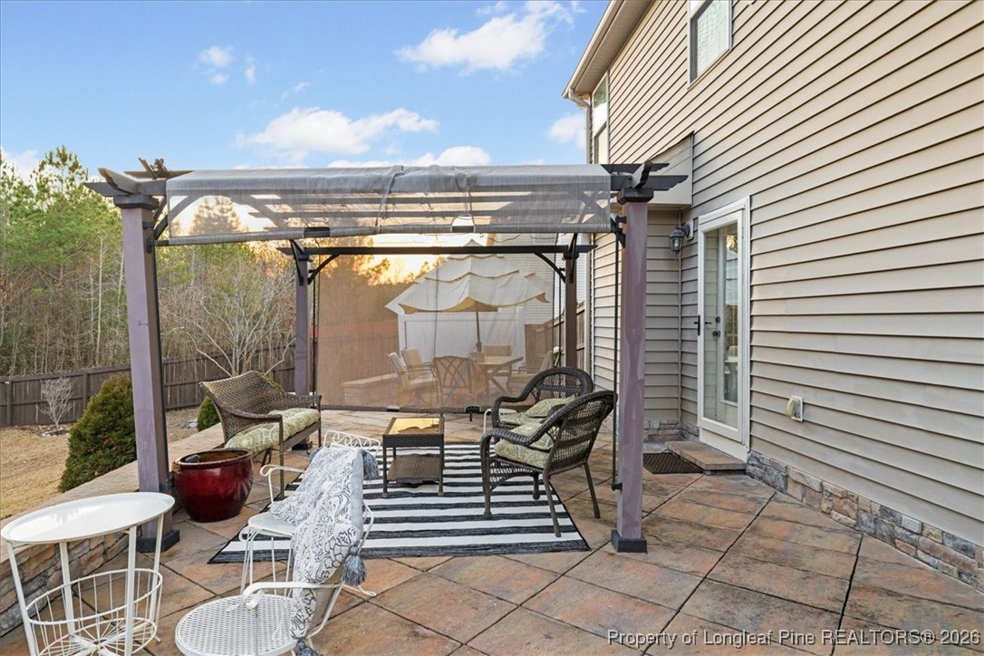 681 New Castle Lane Spring Lake, NC 28390 - Photo 43 of 50 a view of a patio with table and chairs and potted plants