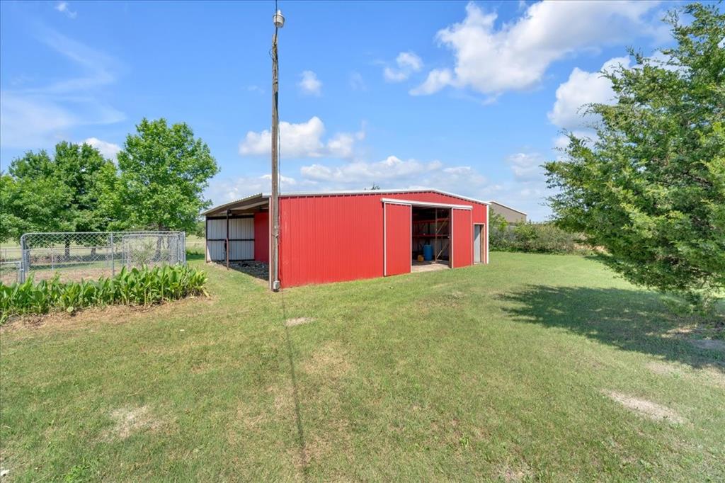 1900 South Duncanville Road Red Oak, TX 75154 - Photo 32 of 39 Huge 30x40 barn with two rollup doors and a walk-in door. Notice the overhang for additional storage.