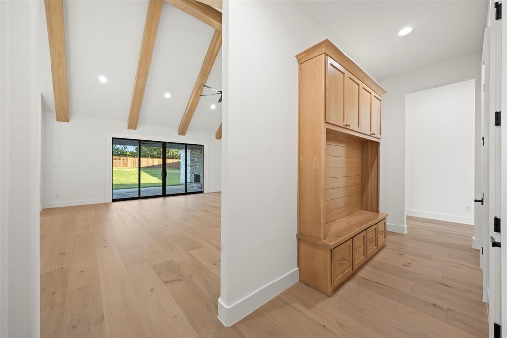 108 Bel Grand Road Haslet, TX 76052 - Photo 13 of 36 Light wood-finish flooring extending throughout, complemented by a built-in wood-finish storage unit with a bench