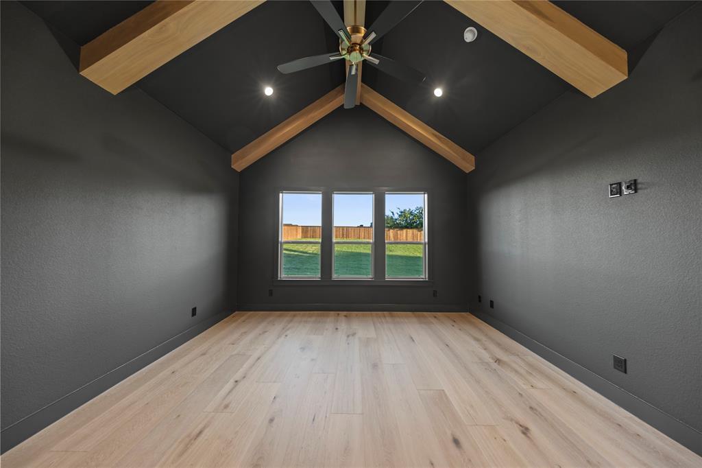 108 Bel Grand Road Haslet, TX 76052 - Photo 25 of 36 Vaulted ceiling with exposed wood beams and a ceiling fan