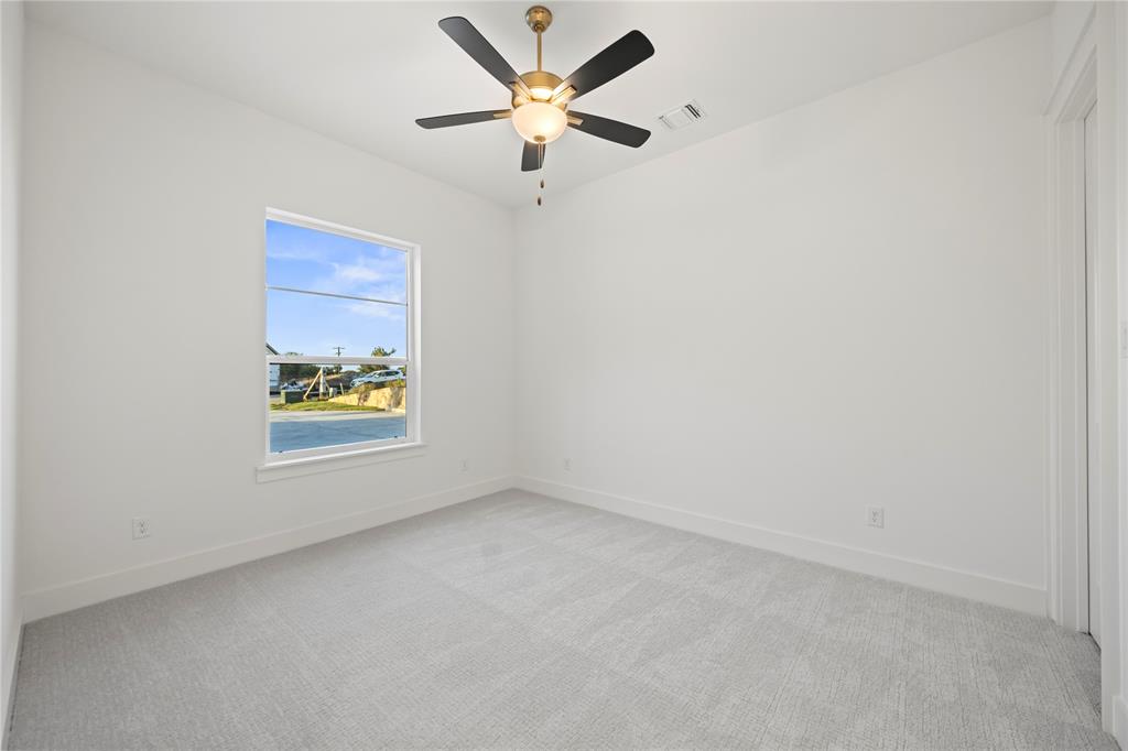 108 Bel Grand Road Haslet, TX 76052 - Photo 27 of 36 Neutral-toned room featuring light gray carpeting, white walls, and a single window with white trim
