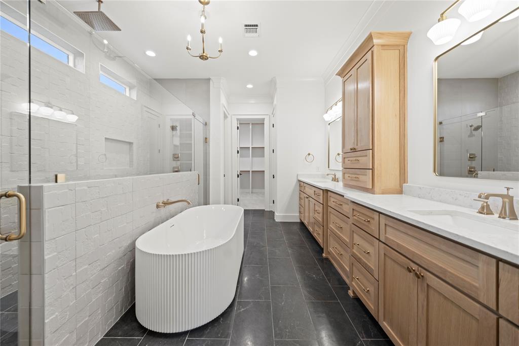 108 Bel Grand Road Haslet, TX 76052 - Photo 29 of 36 Spacious bathroom featuring a fluted freestanding tub, a large walk-in shower with a rain showerhead, a dual vanity with light-tone wood cabinetry, and dark tile flooring