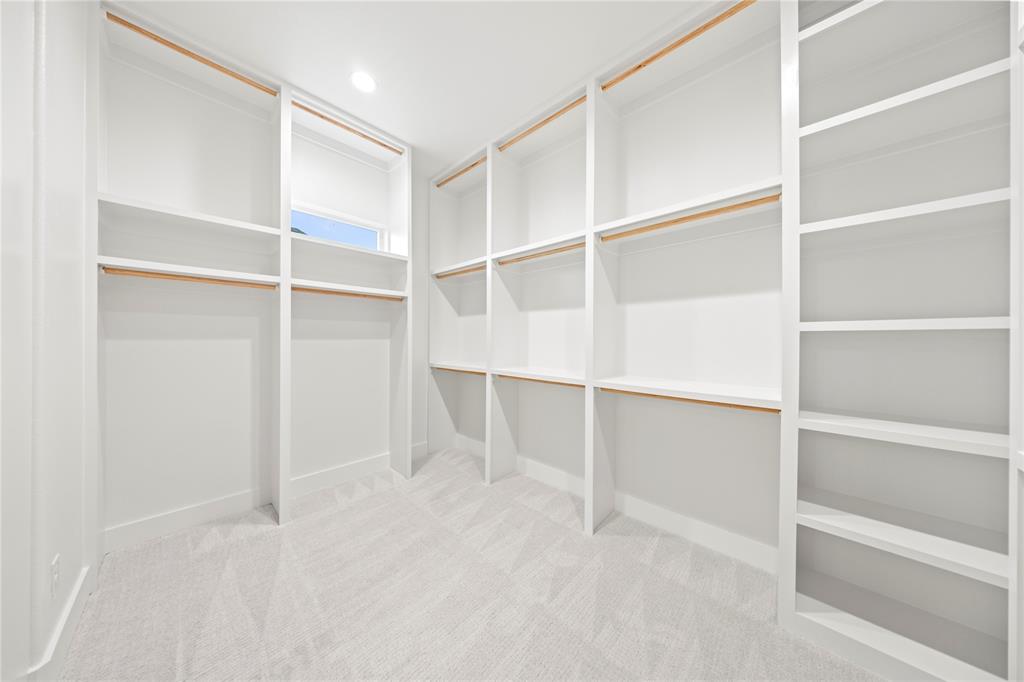 108 Bel Grand Road Haslet, TX 76052 - Photo 33 of 36 Walk-in closet featuring extensive built-in shelving, multiple hanging rods, recessed lighting, and soft carpet flooring
