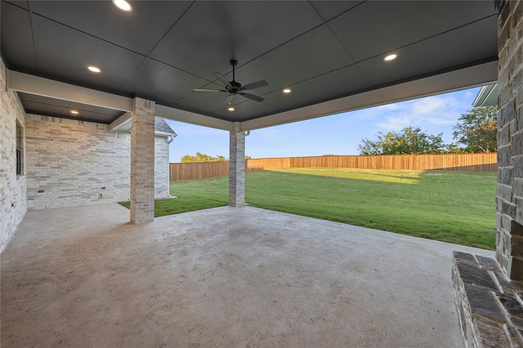 108 Bel Grand Road Haslet, TX 76052 - Photo 35 of 36 Covered patio with a concrete surface, featuring brick-clad support columns and a dark paneled ceiling with recessed lighting and a ceiling fan
