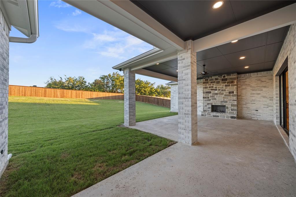 108 Bel Grand Road Haslet, TX 76052 - Photo 36 of 36 Covered patio featuring recessed lighting, a ceiling fan, and a stone-clad outdoor fireplace