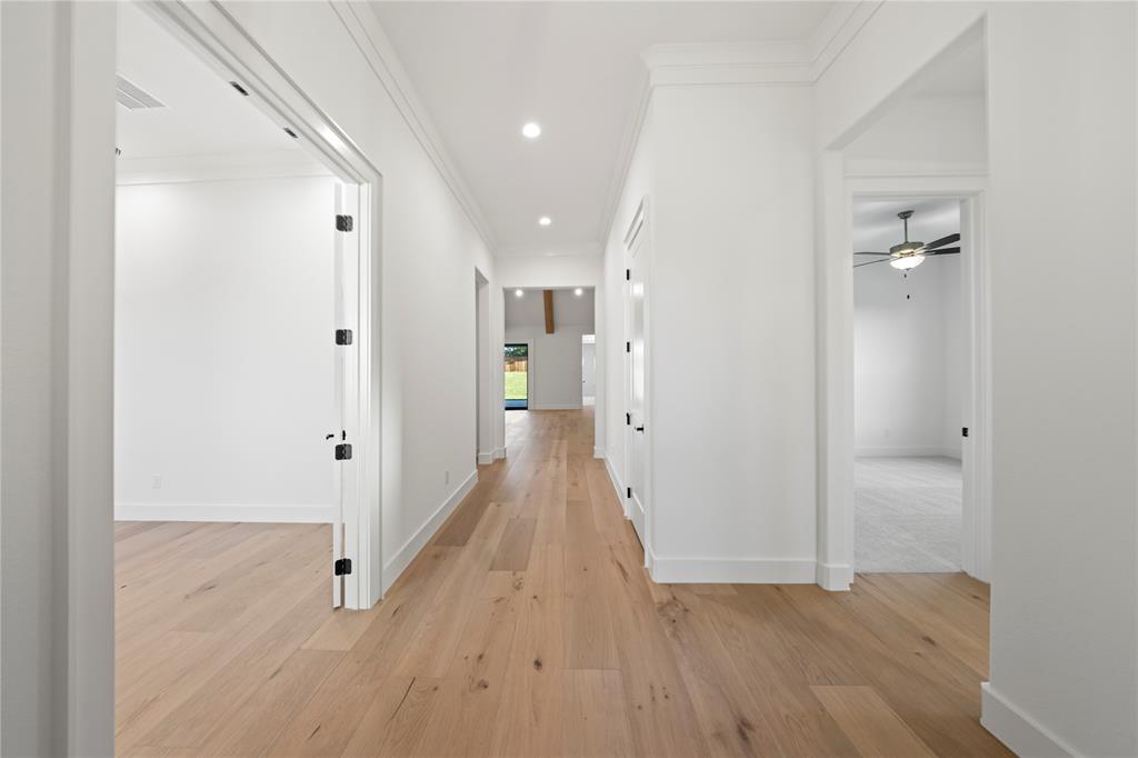 108 Bel Grand Road Haslet, TX 76052 - Photo 5 of 36 Hallway featuring light wood-finish flooring, recessed ceiling lighting, and crisp white walls