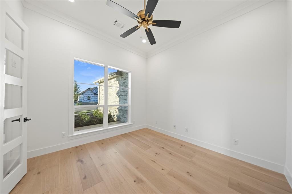 108 Bel Grand Road Haslet, TX 76052 - Photo 6 of 36 Bright room with wood-finish flooring, a contemporary ceiling fan, and a transom window