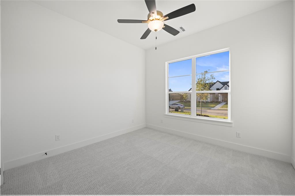108 Bel Grand Road Haslet, TX 76052 - Photo 9 of 36 Interior room featuring a large window, light gray carpeting, and a ceiling fan with integrated lighting