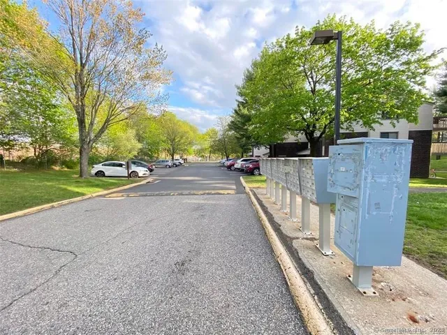 a view of a pathway with a wrought fence