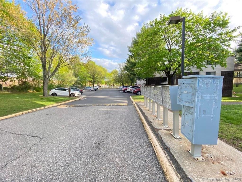 7 Padanaram Road, Unit I181 Danbury, CT 06811 - Photo 14 of 20 a view of a pathway with a wrought fence