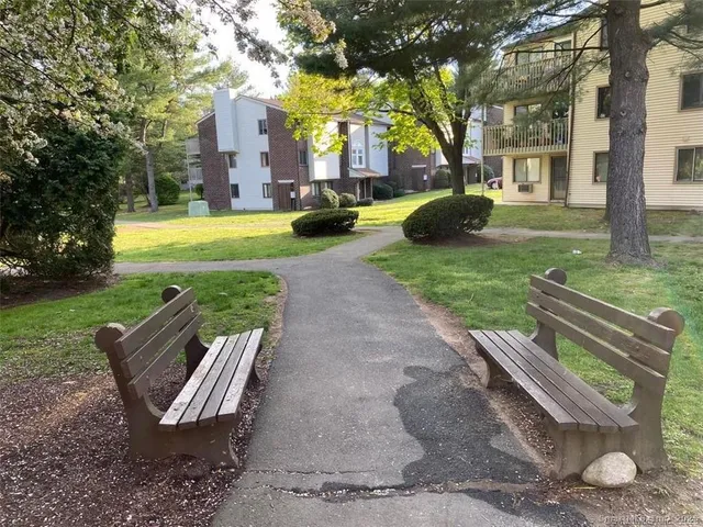 a view of a house with backyard and sitting area