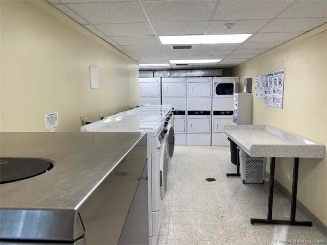 a kitchen with a table chairs and a refrigerator