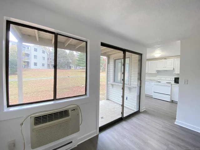 a view of kitchen with furniture and refrigerator