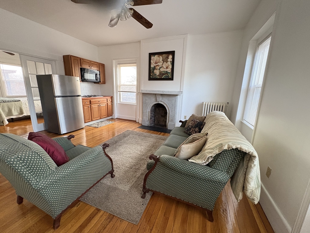 21 Juniper Street, Unit 2 Boston, MA 02119 - Photo 2 of 12 a living room with furniture or fireplace and a flat screen tv