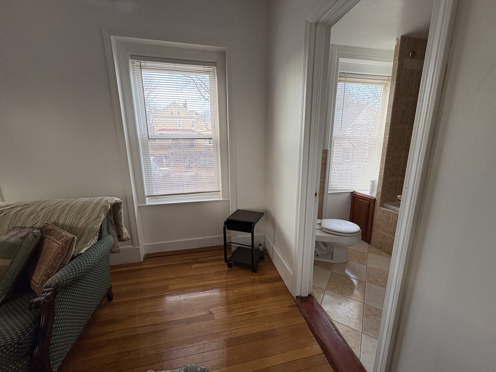 21 Juniper Street, Unit 2 Boston, MA 02119 - Photo 9 of 12 a room with a bed and a window