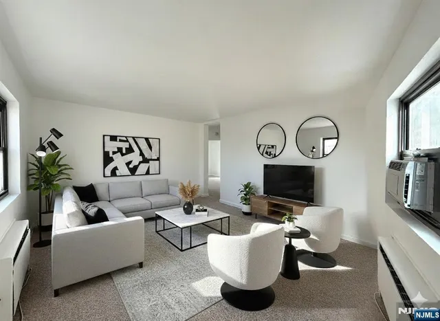 a living room with furniture a flat screen tv and a fireplace