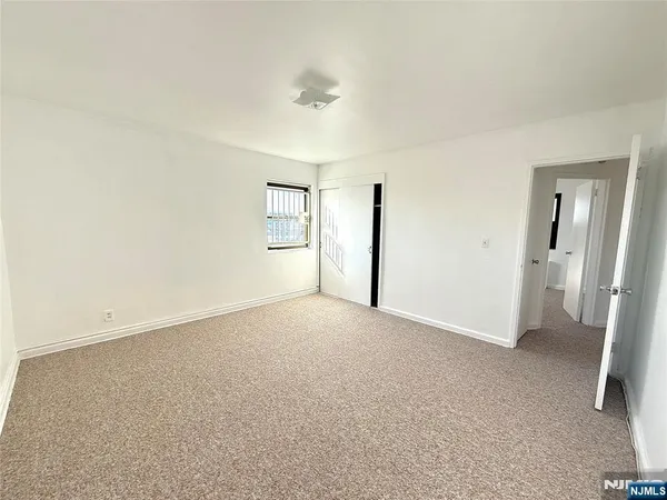 an empty room with a empty space and windows