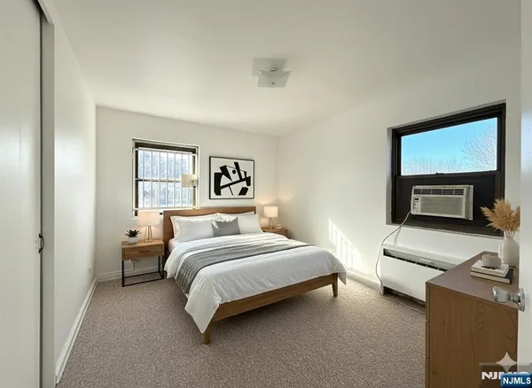 a spacious bedroom with a bed and a television