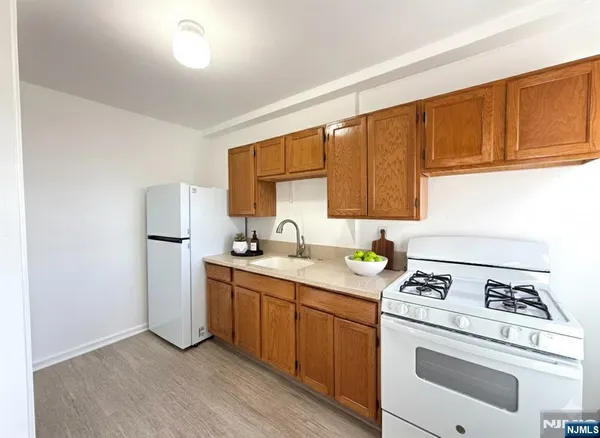 a kitchen with a sink stove and refrigerator