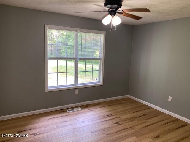 415 Mills Darden Road Lexington, TN 38351 - Photo 11 of 30 a view of an empty room with wooden floor and a window