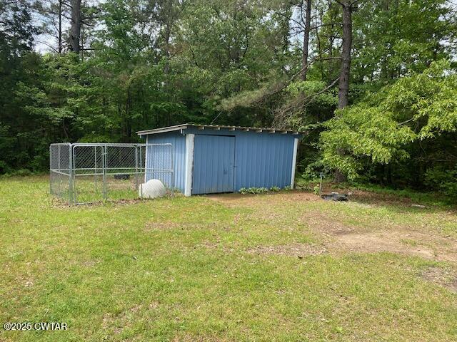 415 Mills Darden Road Lexington, TN 38351 - Photo 22 of 30 a view of a backyard with large trees and wooden fence