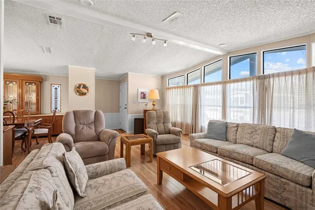 a living room with furniture ceiling fan and a rug