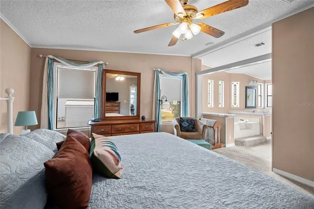 a bedroom with a large bed and a chandelier