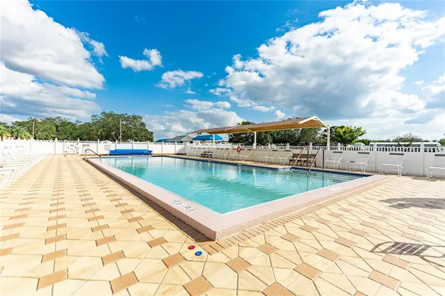 a view of a swimming pool with a patio